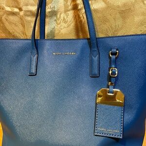 Michael Kors blue tote, floral interior, magnetic closure.   H1Da